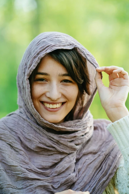 a woman in a shawl smiling for the camera