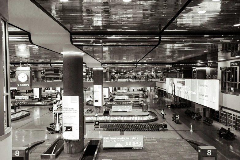 a black and white po of airport with multiple baggage racks