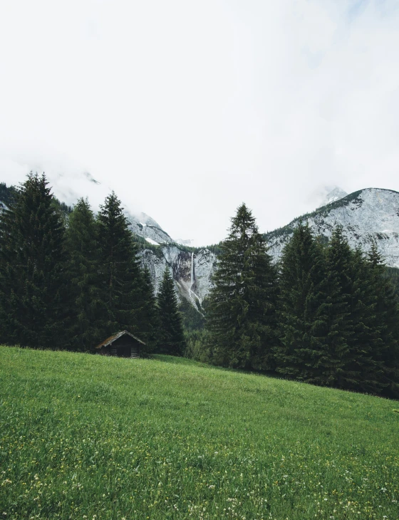 a small cabin sitting on a green hillside