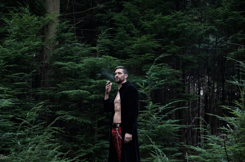 a man standing on a road smoking a cigarette