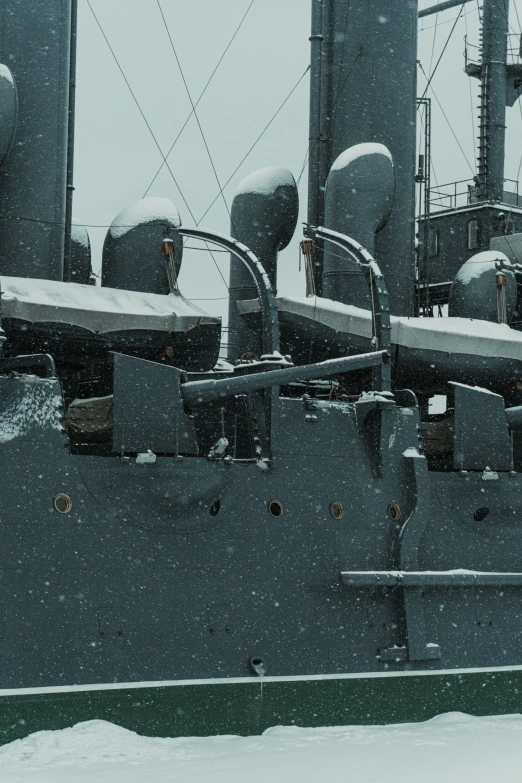 a view of a ship in snow with many pipes