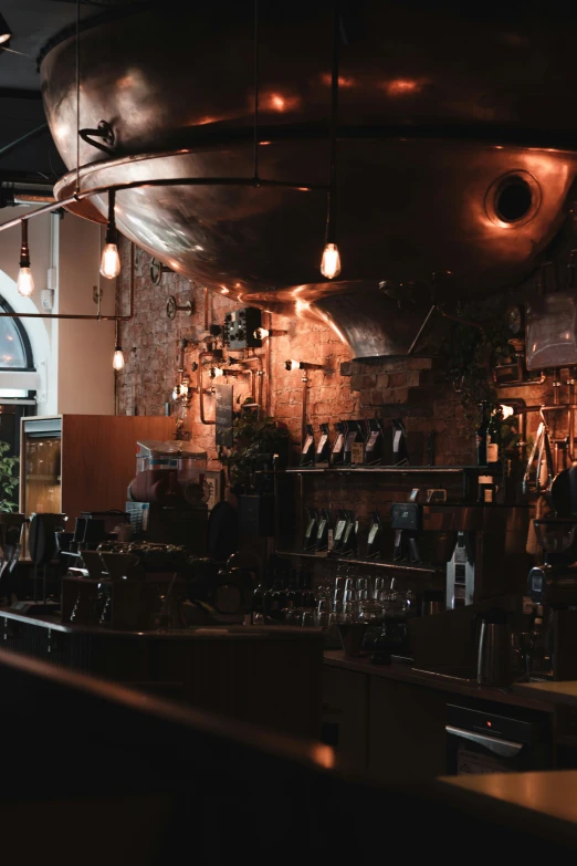 a restaurant with a brick wall, metal ceiling and an arched doorway