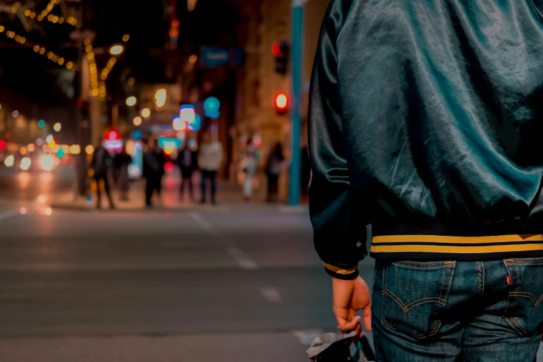 the back end of a man with his skateboard on the street