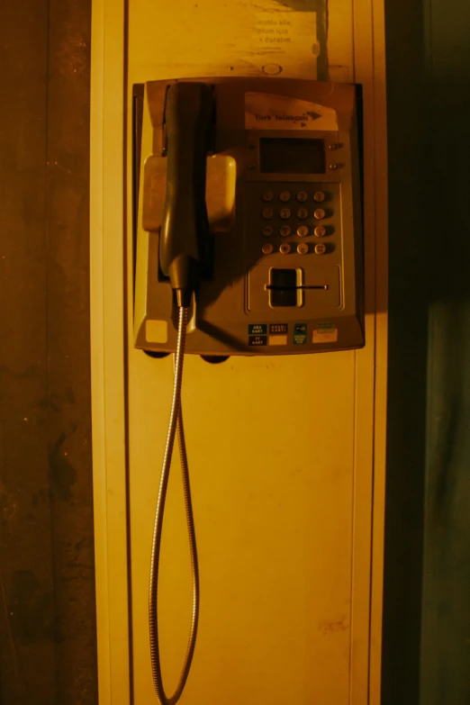 a telephone is seen hanging on the wall