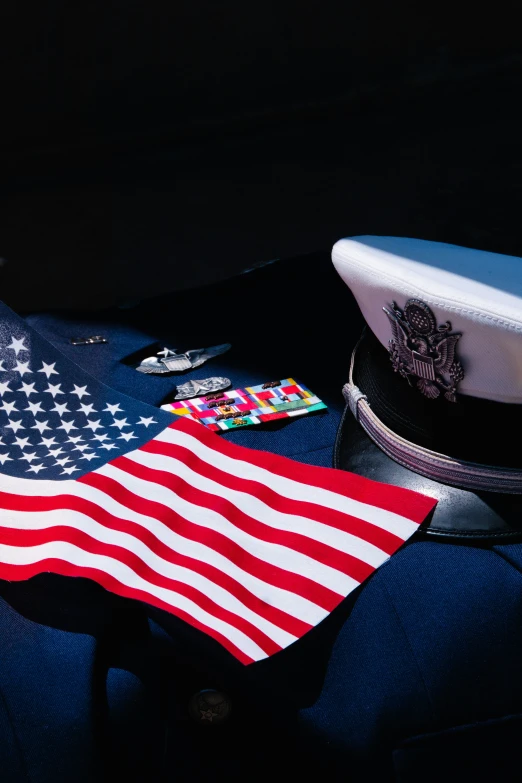 the american flag and a navy uniform laying on a bed