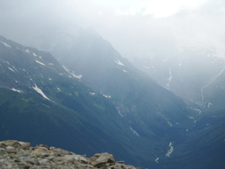 an airplane is traveling on a mountain range