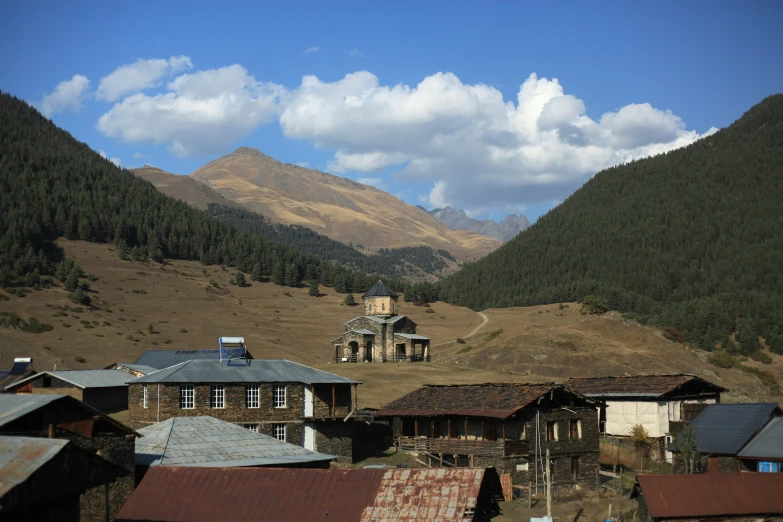 many buildings are on the hillside beside the hills