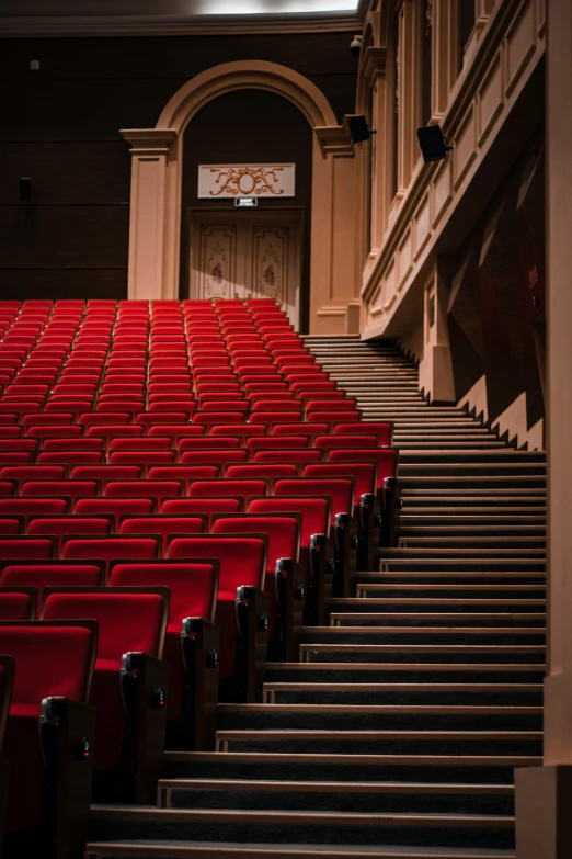 a po of red seats in the auditorium of a movie theatre