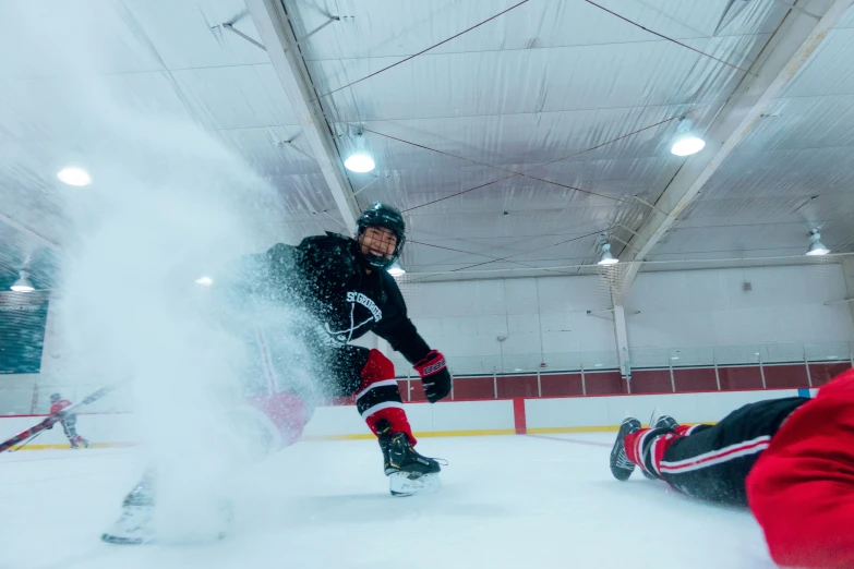 there is a man skating on an ice rink