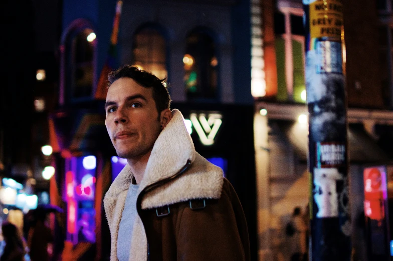 a man is standing on a busy street