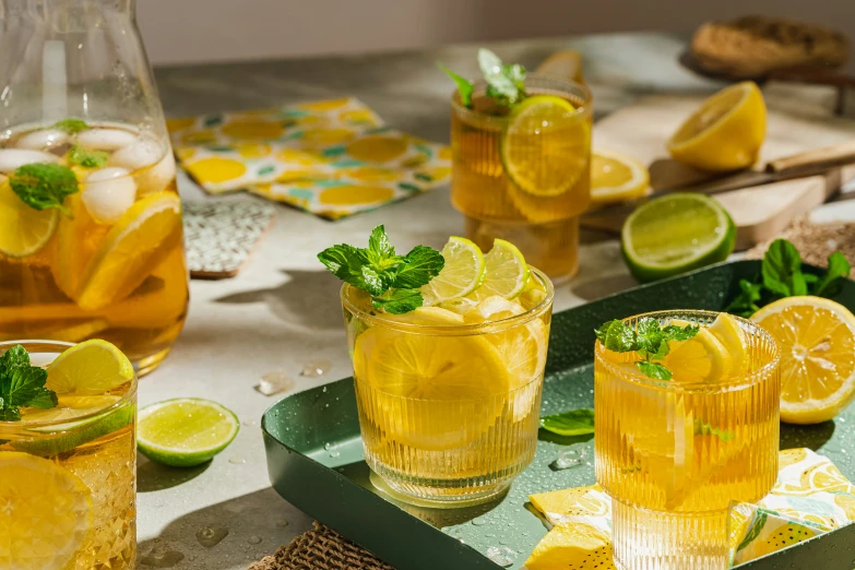 a wooden table topped with three glasses and drinks