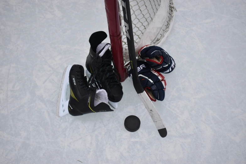 a hockey goal and pair of socks sitting on the ice