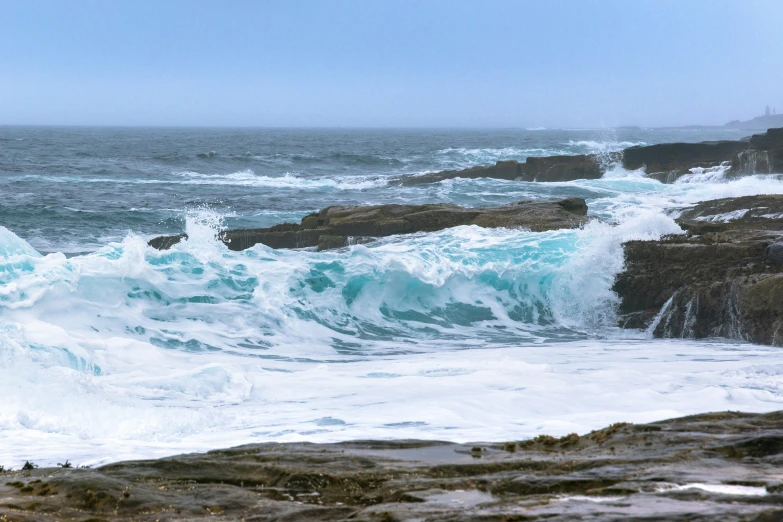 a view of the ocean from a rocky shore