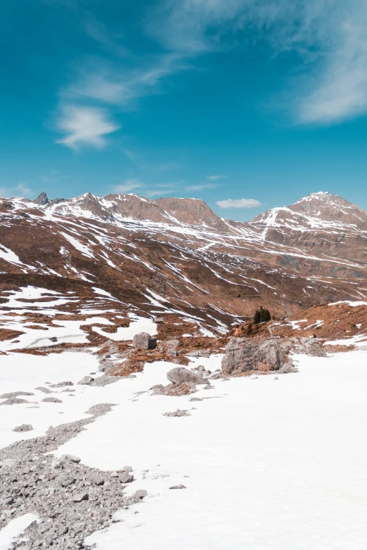 a man is riding a snowboard on top of a snowy hill