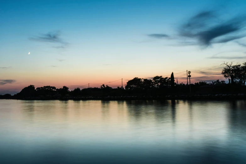 the sunset reflects on water and trees