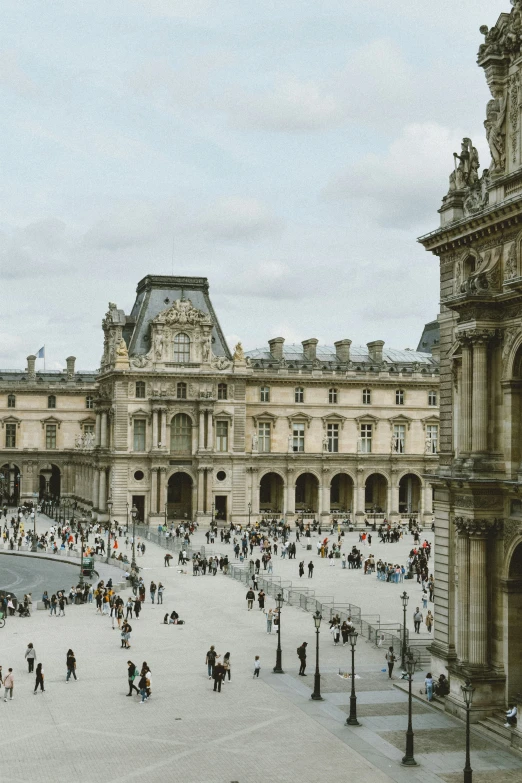 a large stone building with people outside of it