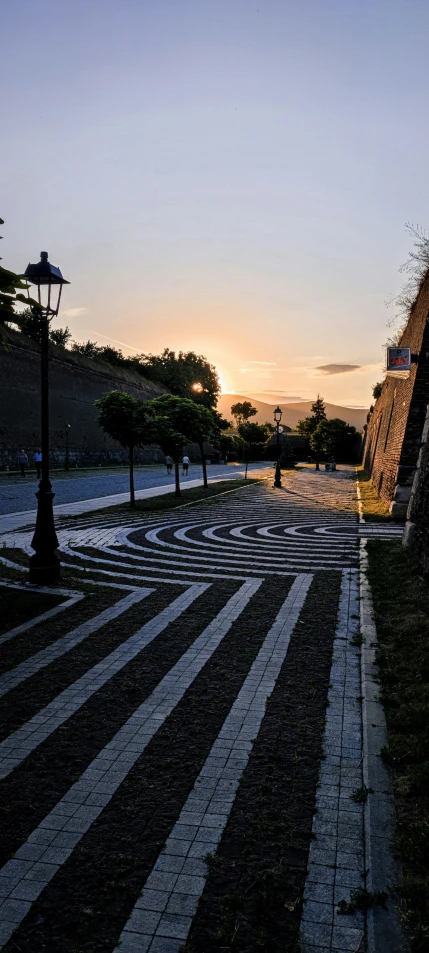 a pathway in the park that has cobblestones on it