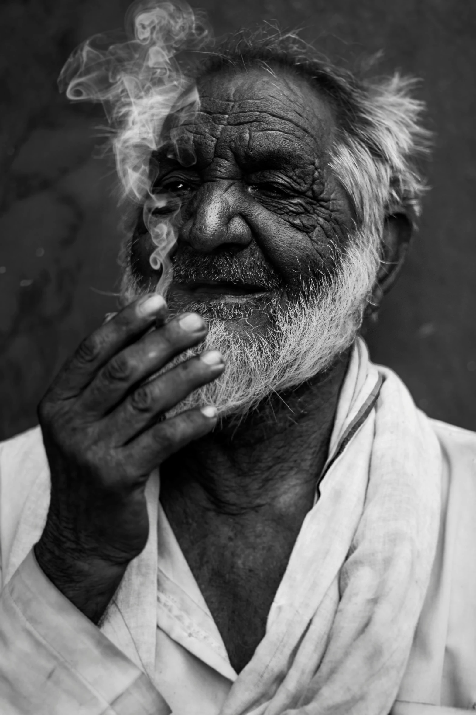 a man is smoking in a black and white po