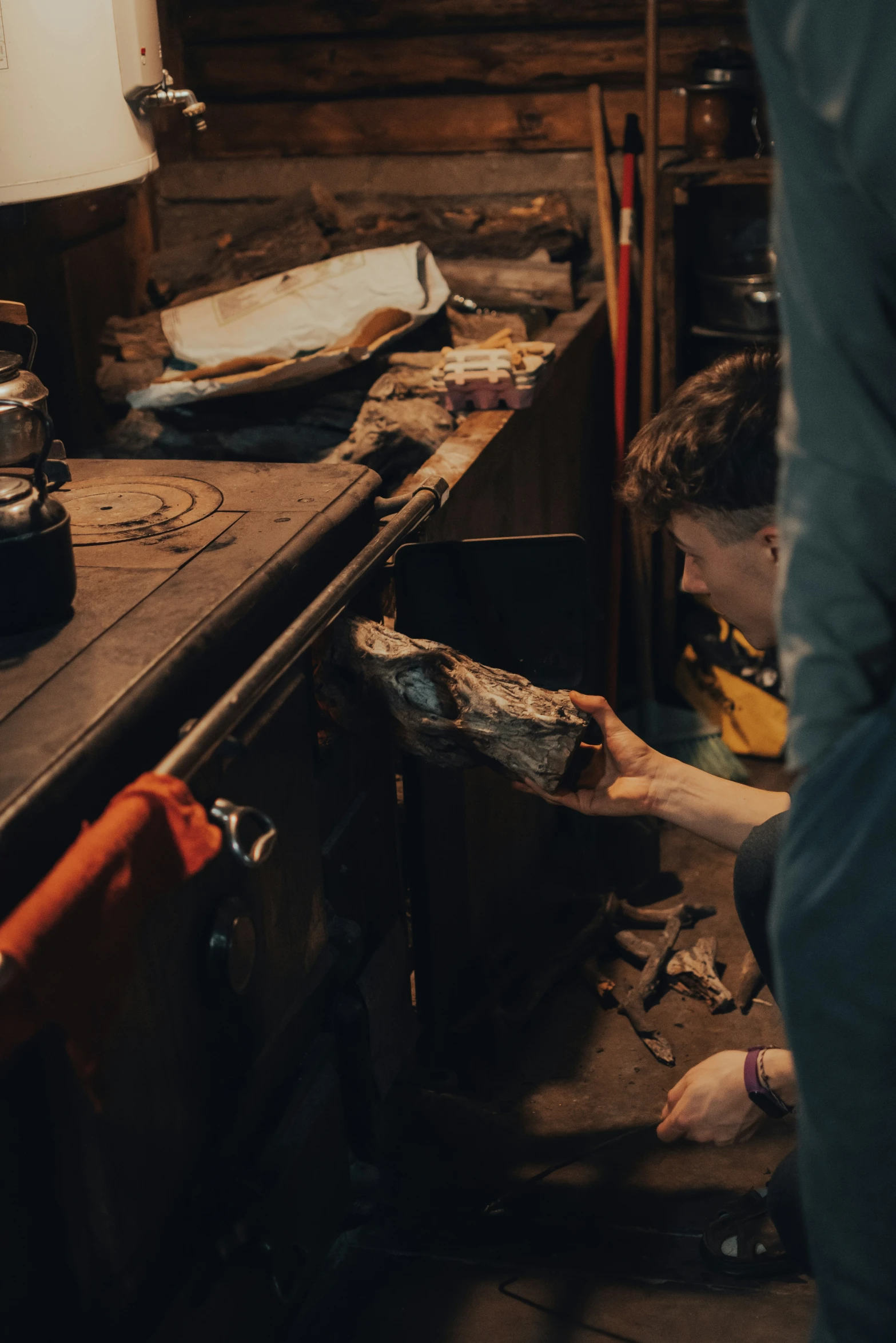 a man working in a kitchen using an open drawer