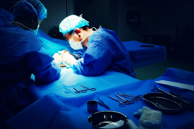 a surgeons performing  for someone laying in bed