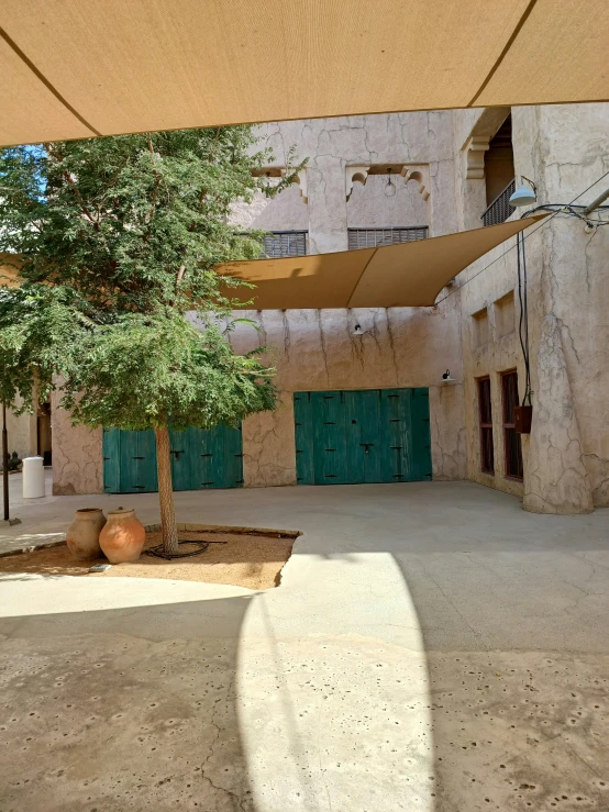 a courtyard under a large tent next to an alley