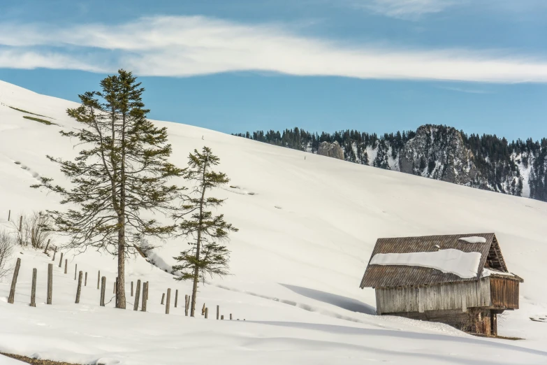 a small cabin in the middle of a snowy mountain