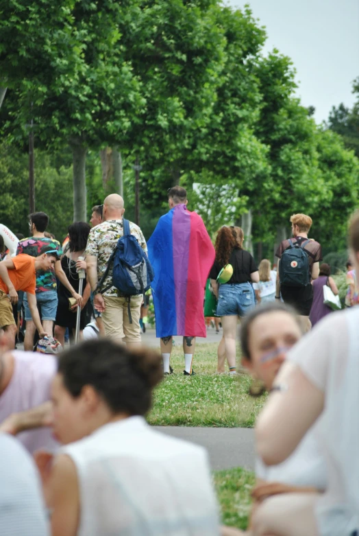 people on the grass walking near a building