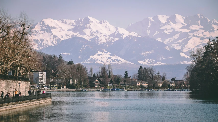 snow covered mountains on the other side of a lake