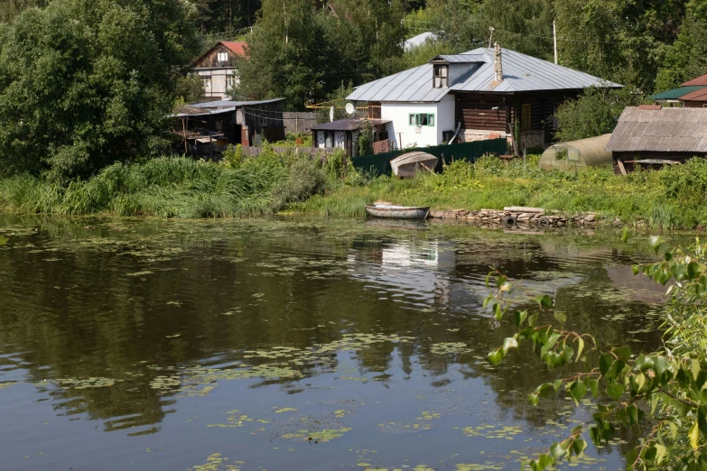 a lake and small village near some trees