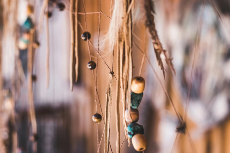 beads strung from grass hanging from the wall