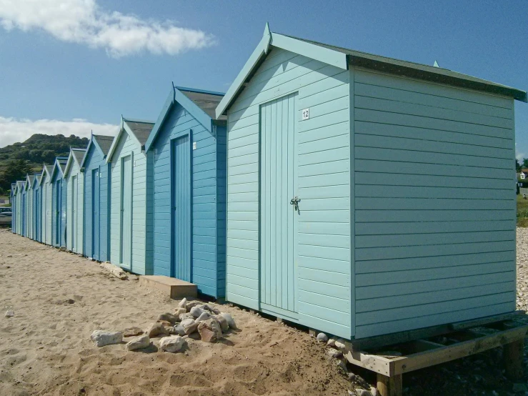 row of beach huts with one sitting on the sand