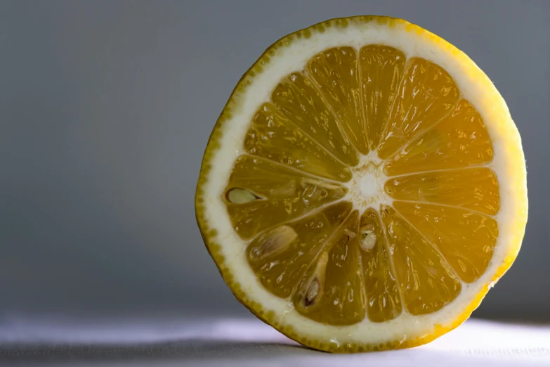 the half of the lemon is sitting on the table