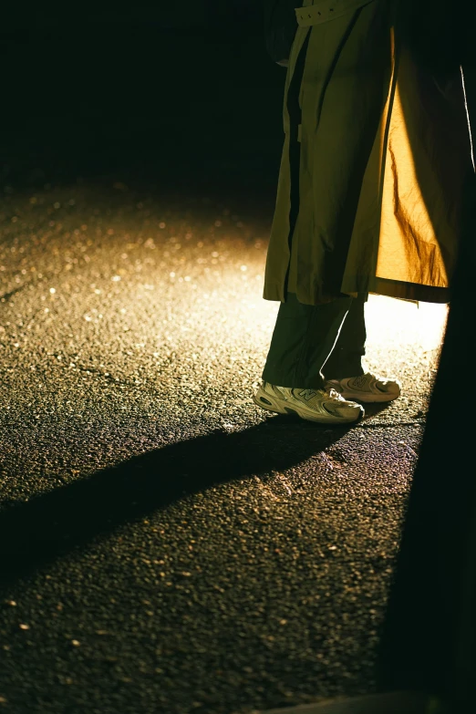 the shadow from a man's shoes as he is walking