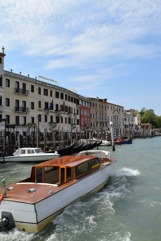 a large boat sailing on the water by buildings