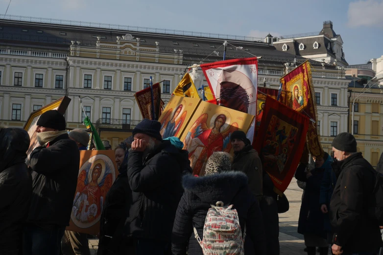 a group of people standing around a flag