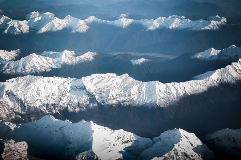 mountains are seen in the distance while viewed from an airplane window