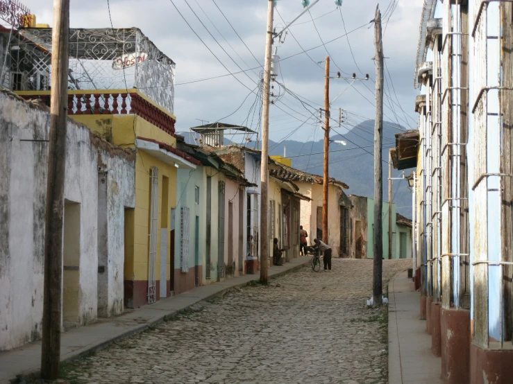 a person is riding his horse down a cobblestone street