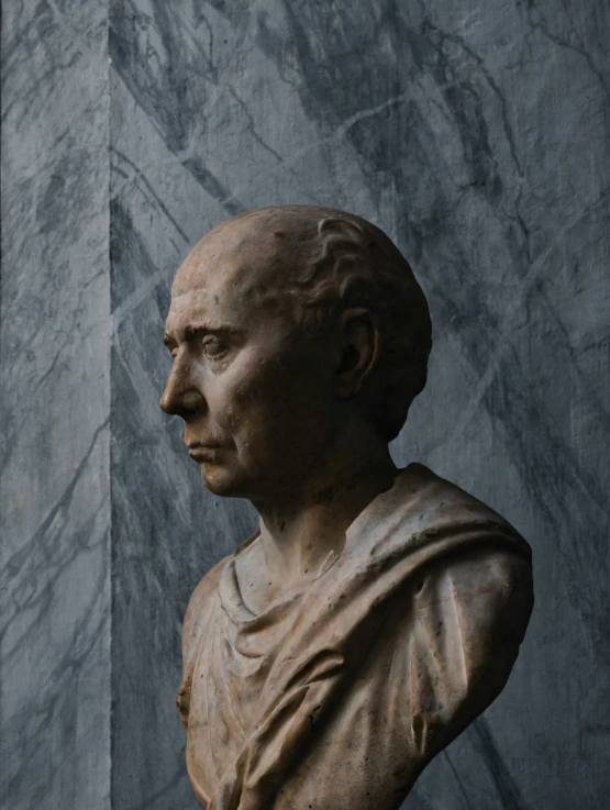 a bust of a man with a hair bun