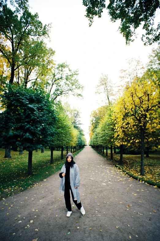 a woman stands in the middle of an empty street