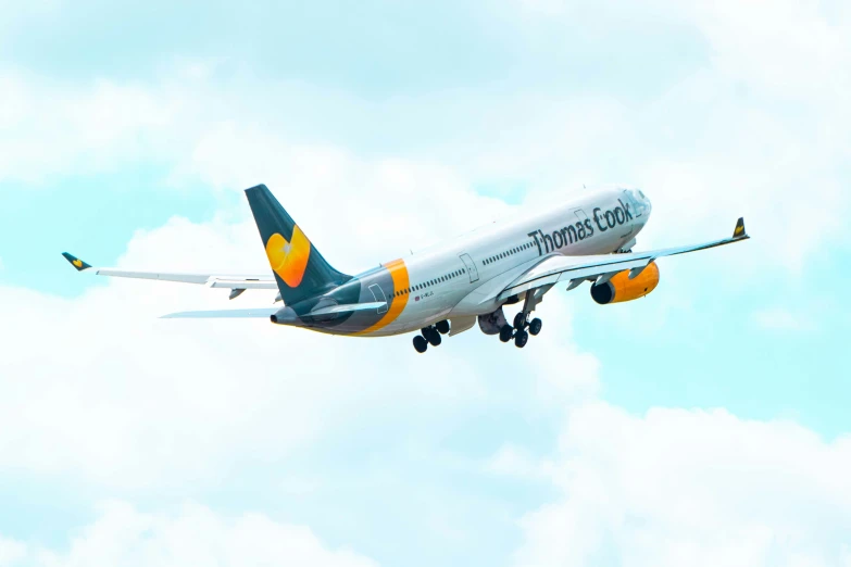 a large air plane flying through a cloudy sky