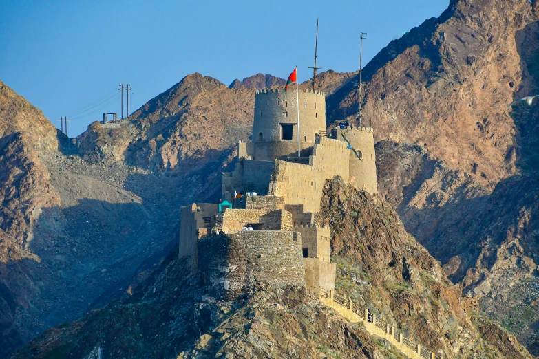 a large castle that is sitting on the side of a mountain