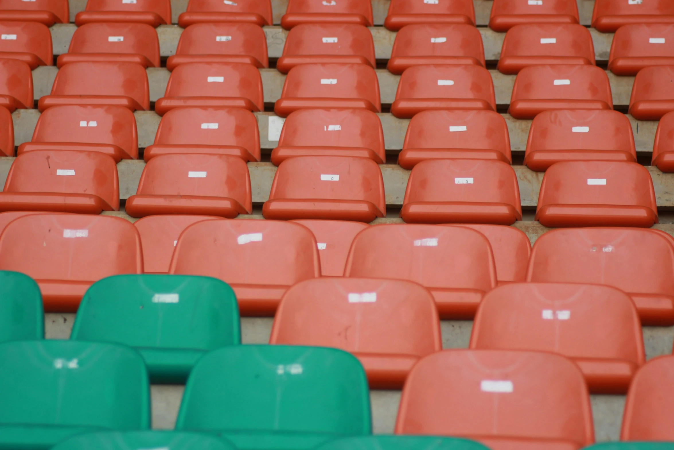 many rows of plastic seats with labels on them