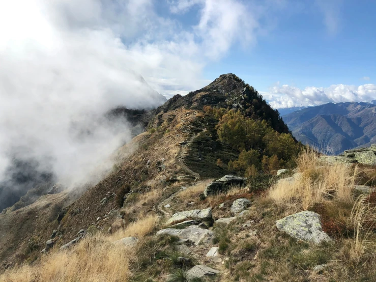 the grassy area has several layers of thick clouds