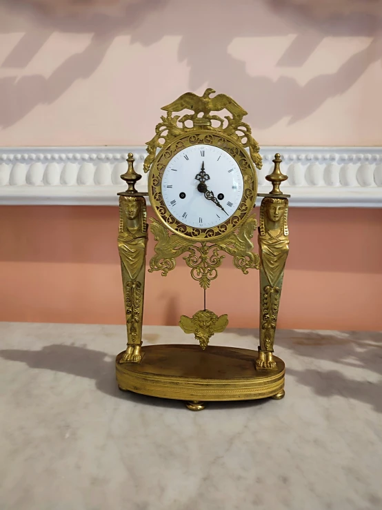 the small antique clock is made of gold