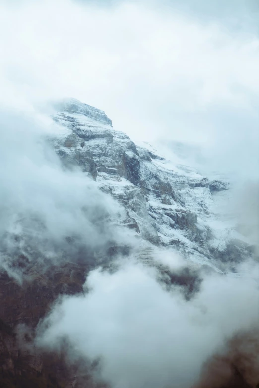 the mountains covered with clouds and a bird flying high