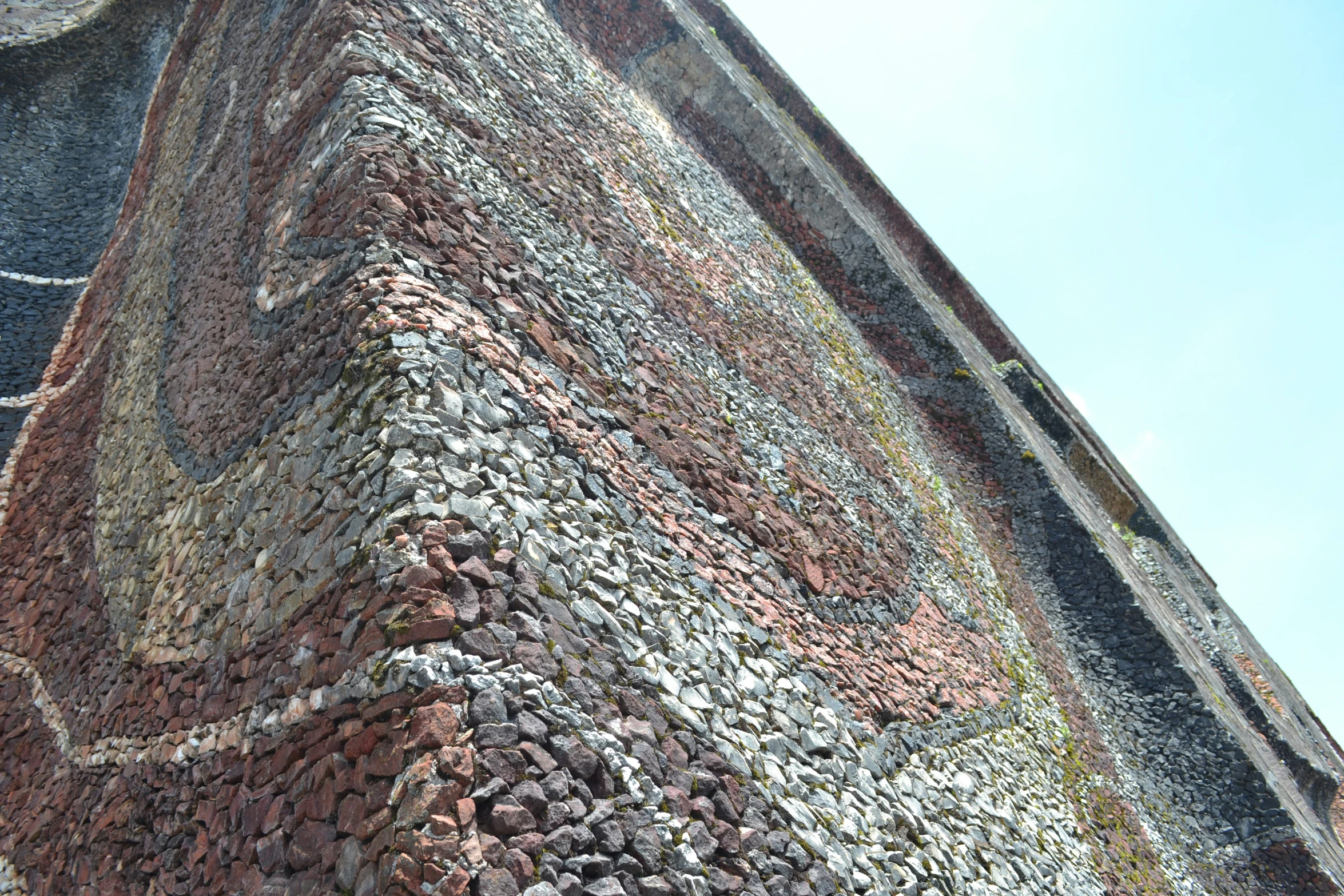 a bird sitting on the top of a tower with brick walls