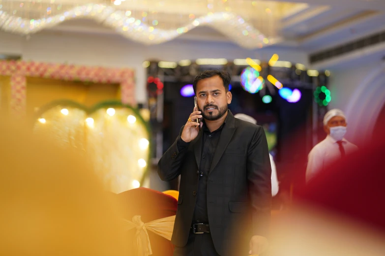 a man wearing a suit talking on his cell phone