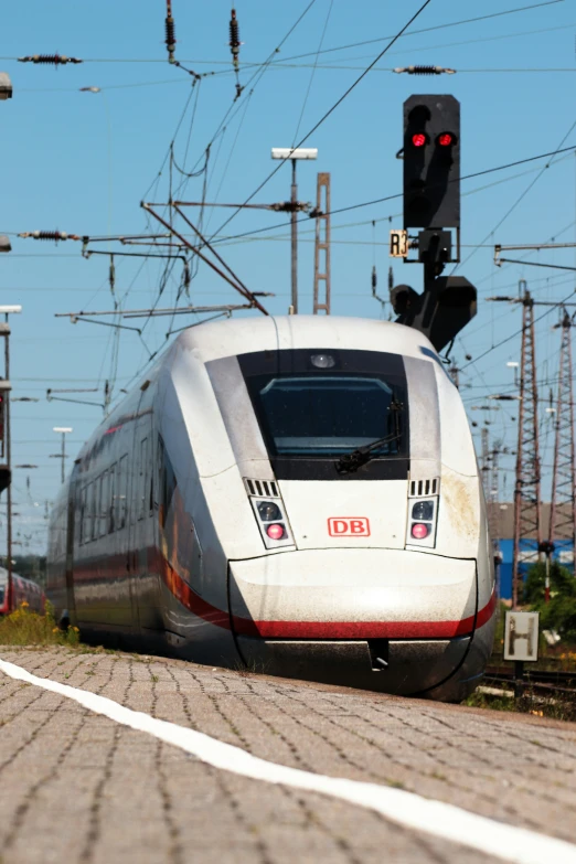 a train traveling down tracks near a traffic light