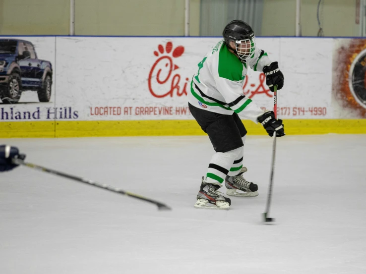 the  is practicing on the ice in uniform