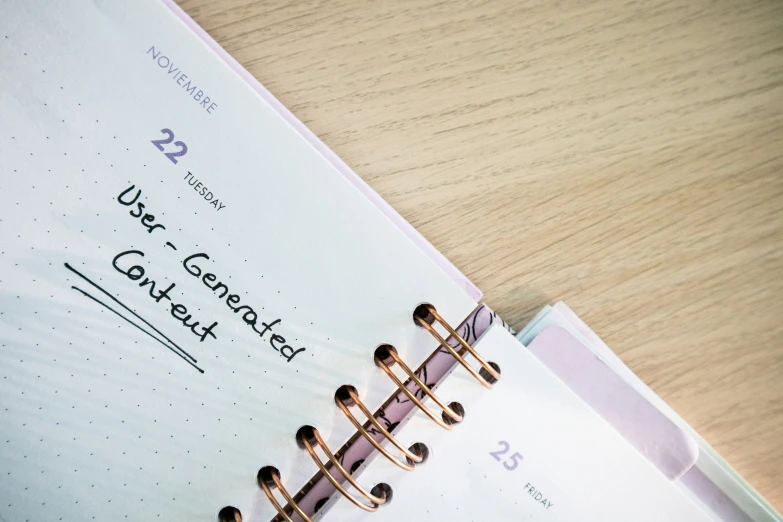 an open spiral bound note book sitting on a desk